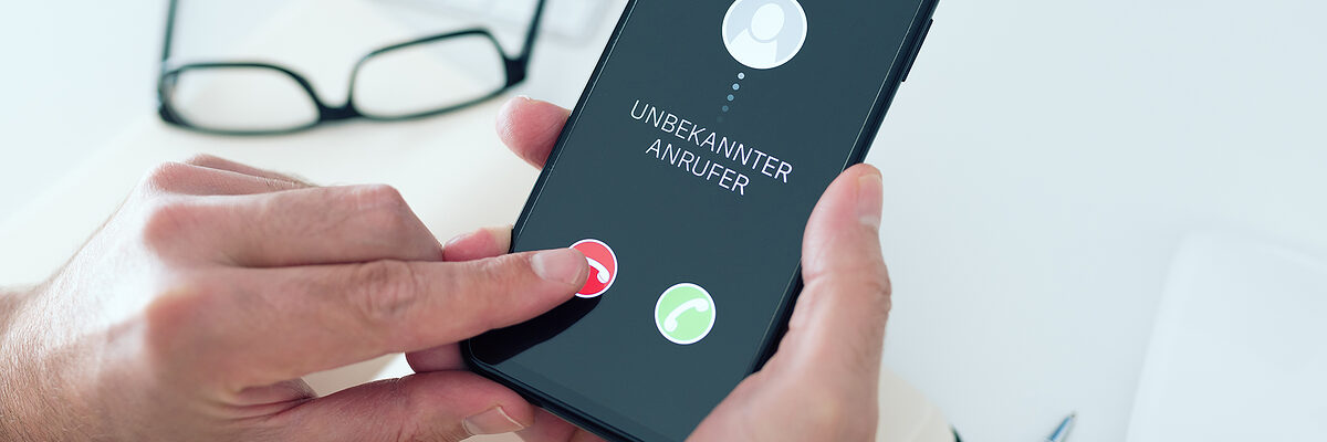 close-up view of person rejecting call from unknown number with text UNBEKANNTER ANRUFER, German for unknown caller, on smartphone, phone scam and phishing concept Schlagwort(e): phone, call, unknown number, unknown caller, rejecting, scam, phishing, smartphone, reject, hang up, german, touch screen, finger, button, annoyance, disturbing, disruption, incoming, incognito, fake, home, mobile phone, screen, stranger, security, concept, suspicious, fraud, answer, cellphone, phone call, ringing, indoors, man, caucasian, lifestyle, unknown, german language, office, desk, communication, holding, phone, call, unknown number, unknown caller, rejecting, scam, phishing, smartphone, reject, hang up, german, touch screen, finger, button, annoyance, disturbing, disruption, incoming, incognito, fake, home, mobile phone, screen, stranger, security, concept, suspicious, fraud, answer, cellphone, phone call, ringing, indoors, man, caucasian, lifestyle, unknown, german language, office, desk, communication, holding