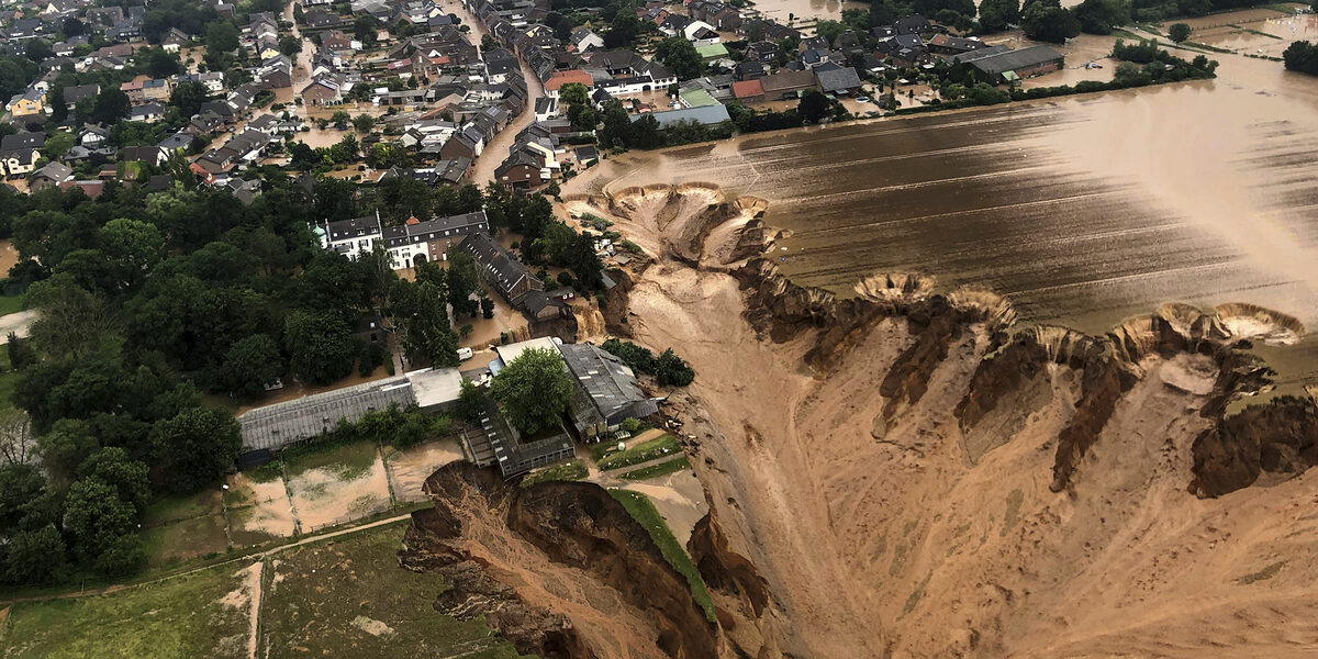 This image provided on Friday, July 16, 2021 by the Cologne district government shows the Blessem district of Erftstadt in Germany. Rescuers were rushing Friday to help people trapped in their homes in the town of Erftstadt, southwest of Cologne. Regional authorities said several people had died after their houses collapsed due to subsidence, and aerial pictures showed what appeared to be a massive sinkhole. (Rhein-Erft-Kreis via AP)