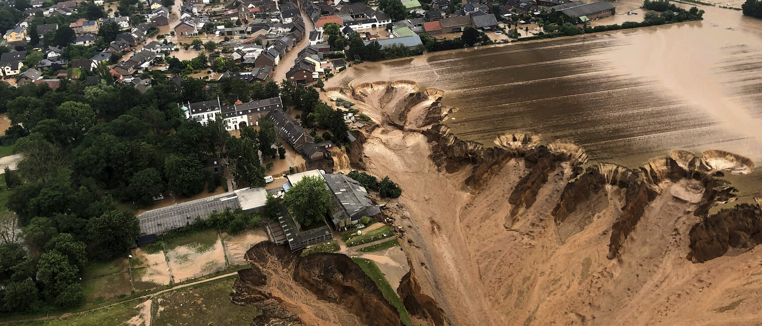 This image provided on Friday, July 16, 2021 by the Cologne district government shows the Blessem district of Erftstadt in Germany. Rescuers were rushing Friday to help people trapped in their homes in the town of Erftstadt, southwest of Cologne. Regional authorities said several people had died after their houses collapsed due to subsidence, and aerial pictures showed what appeared to be a massive sinkhole. (Rhein-Erft-Kreis via AP)